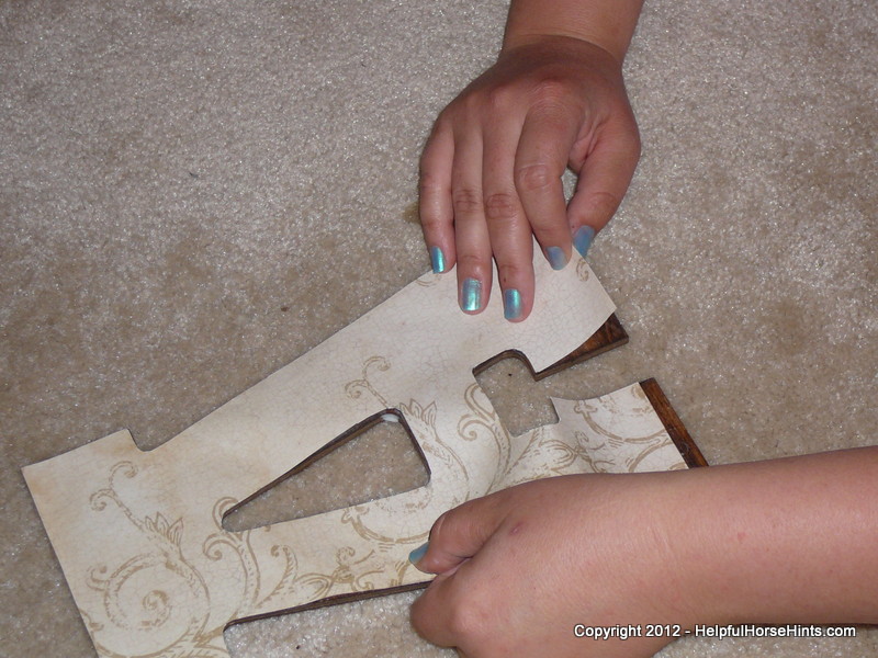 carefully placing the decorative paper onto the wood stall sign lighter