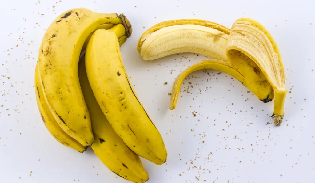 peeled banana on a white table