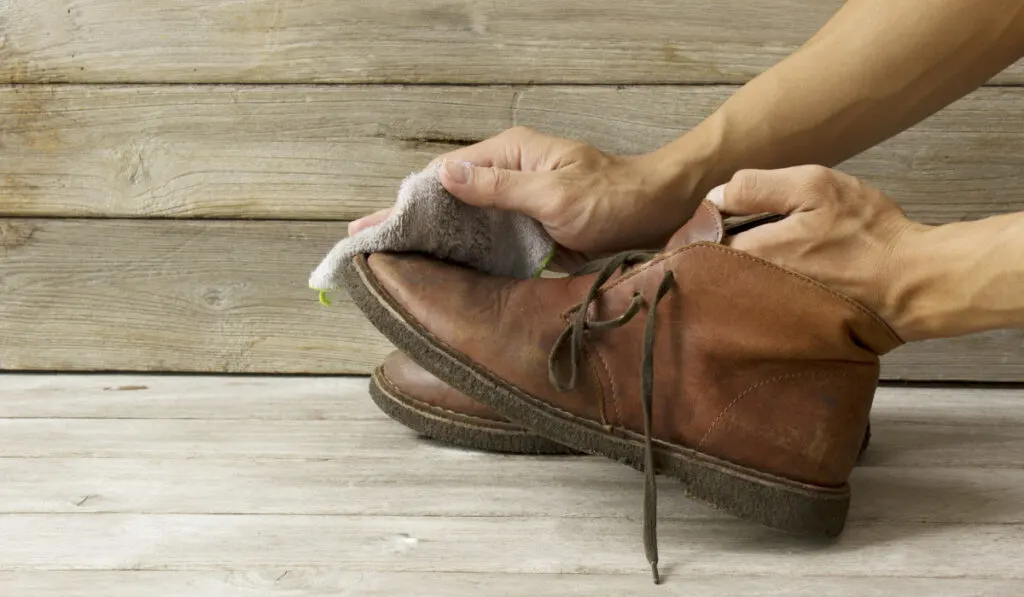 man cleaning the shoes