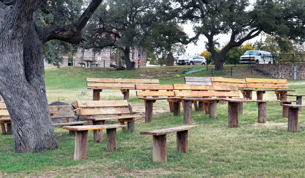 Cowboy Church in the park with wooden benches