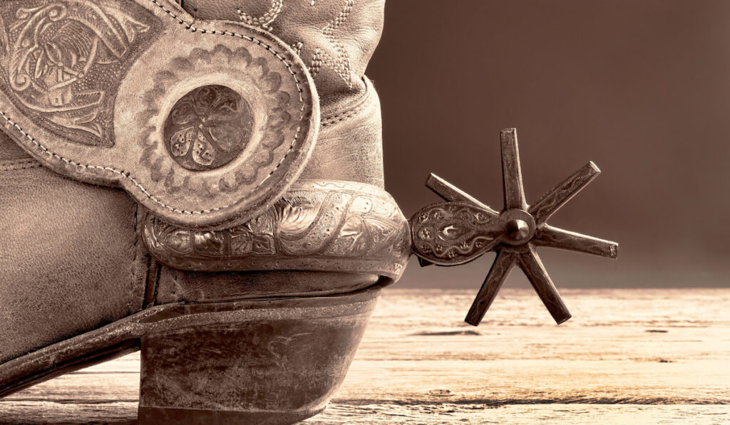 Cowboy boots and Mexican spurs in black and white sepia tone