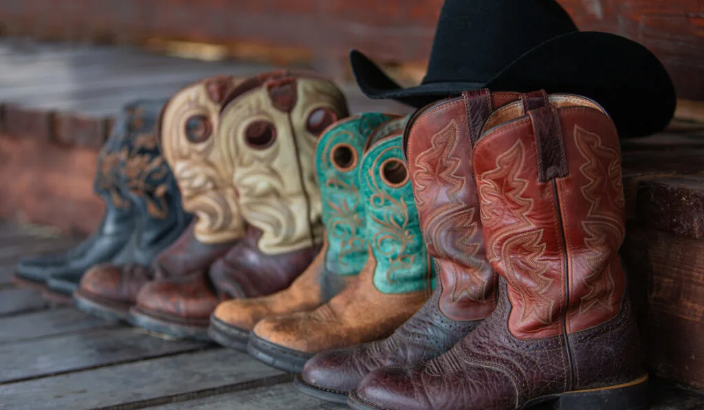 Cowboy boots stand on a wooden floor