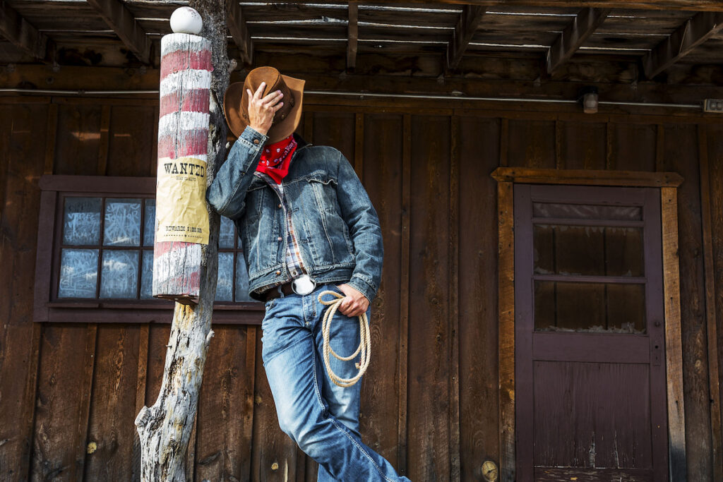 Cowboy resting, covering his face with his cowboy hat