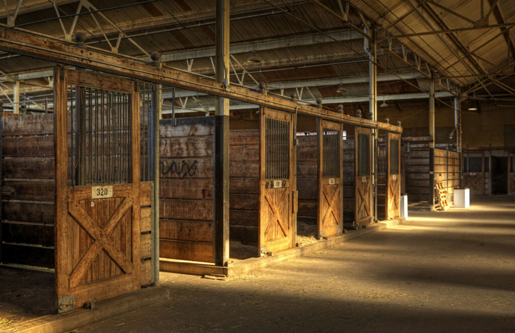 Empty wooden stalls in a horse facility