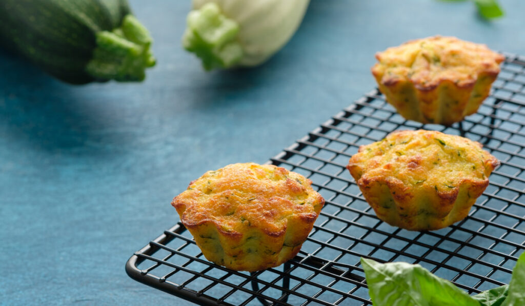 Freshly baked Zucchini muffins on black tray 