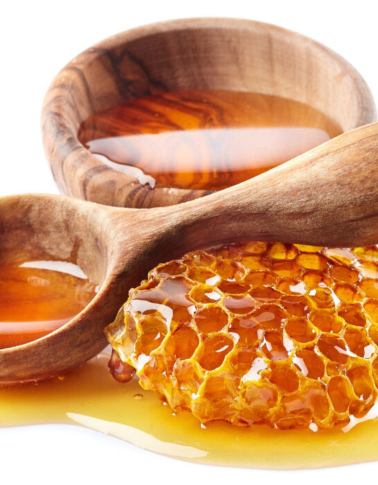 Honey with honeycomb and wooden spoon