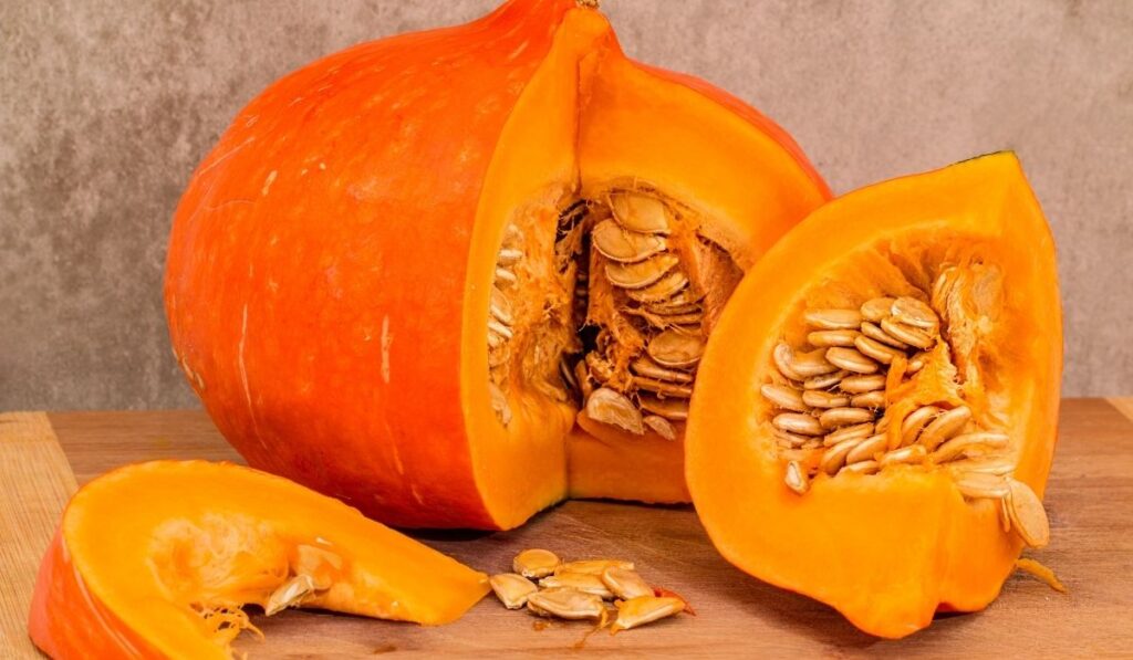 Sliced pumpkins on wooden table