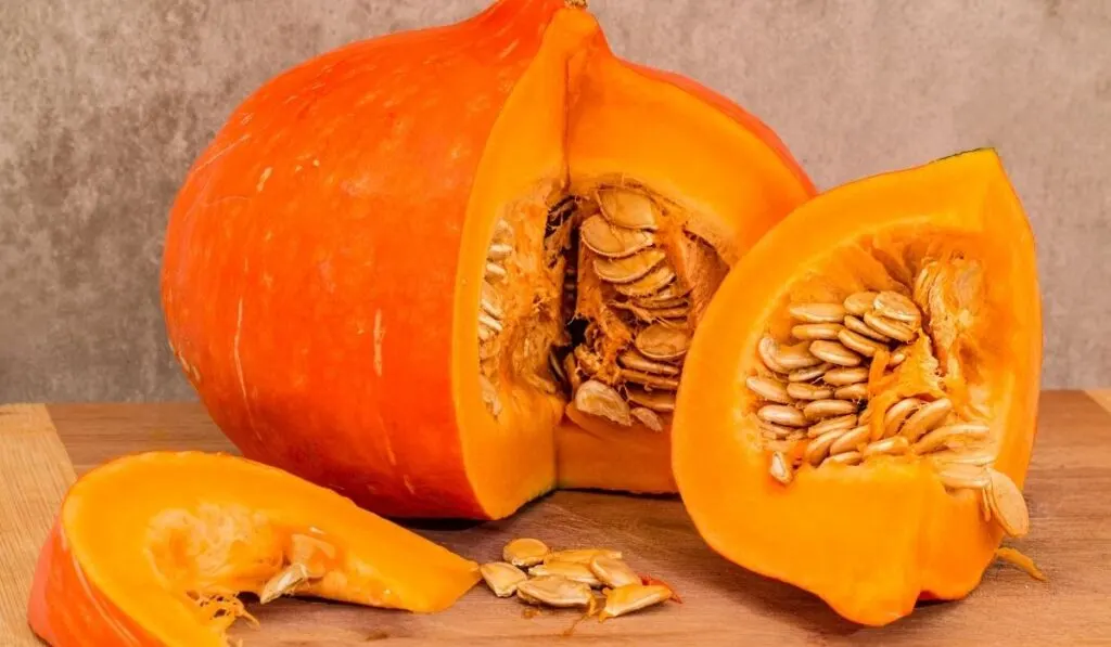 Sliced pumpkins on wooden table