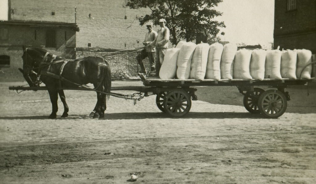 Vintage photo of horse drawn wagon transporting bags