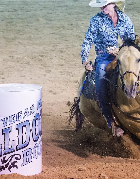 a horse and rider competing in a barrel race