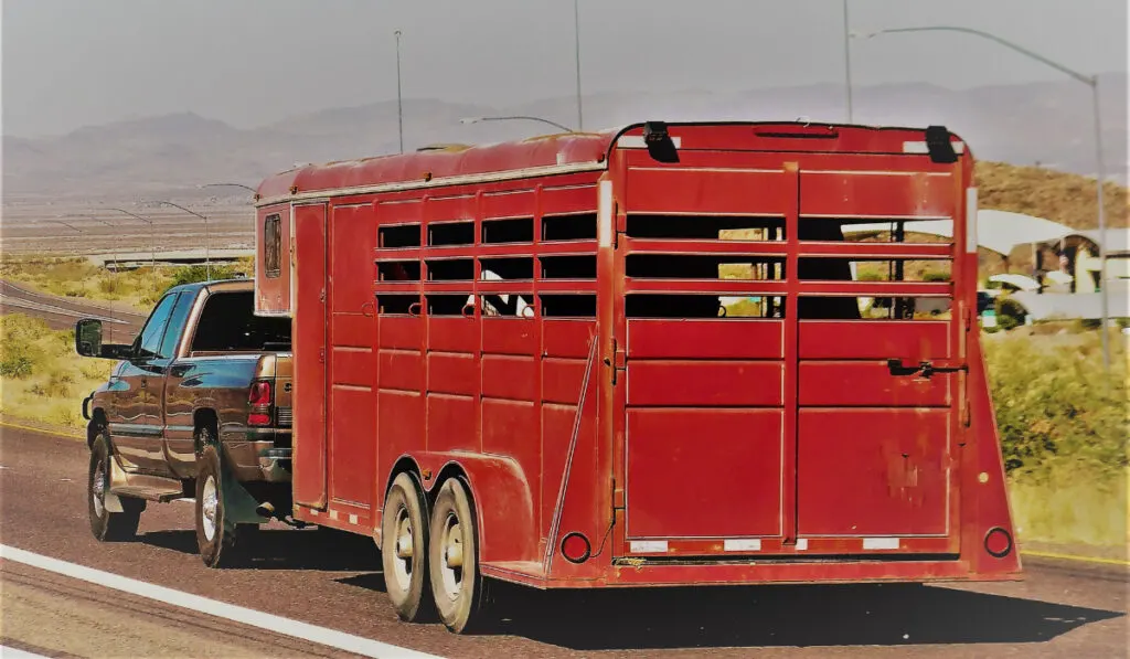 a red horse trailer on the open road
