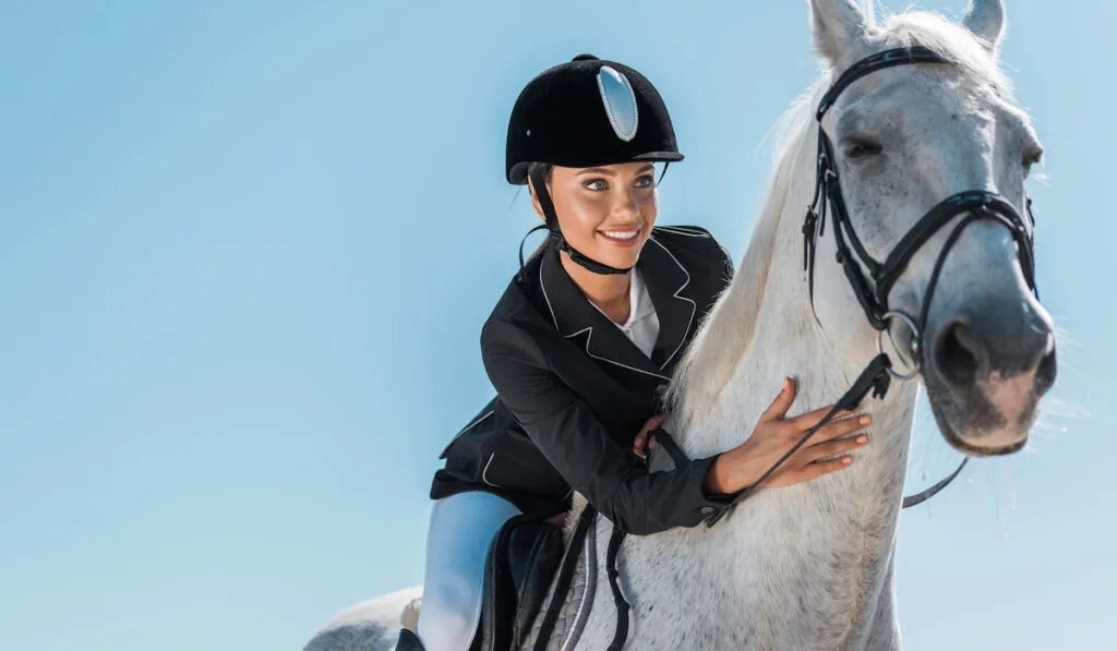 attractive woman riding her horse