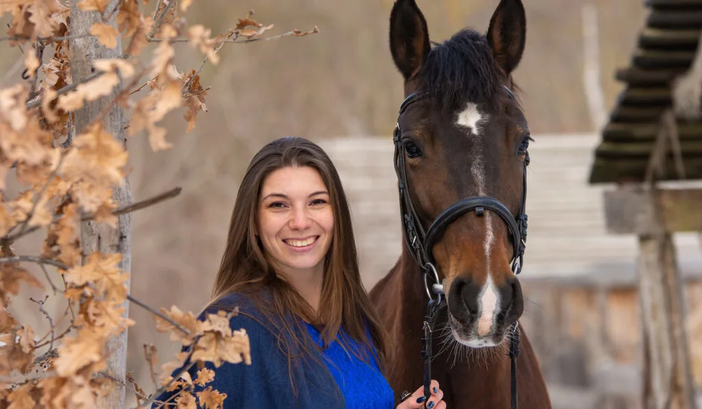 beautiful woman spending time with her horse