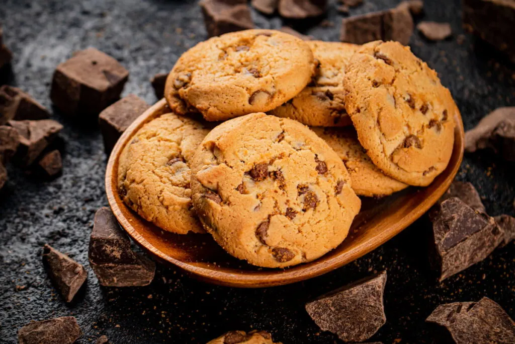 chocolate chip cookies on a wooden saucer