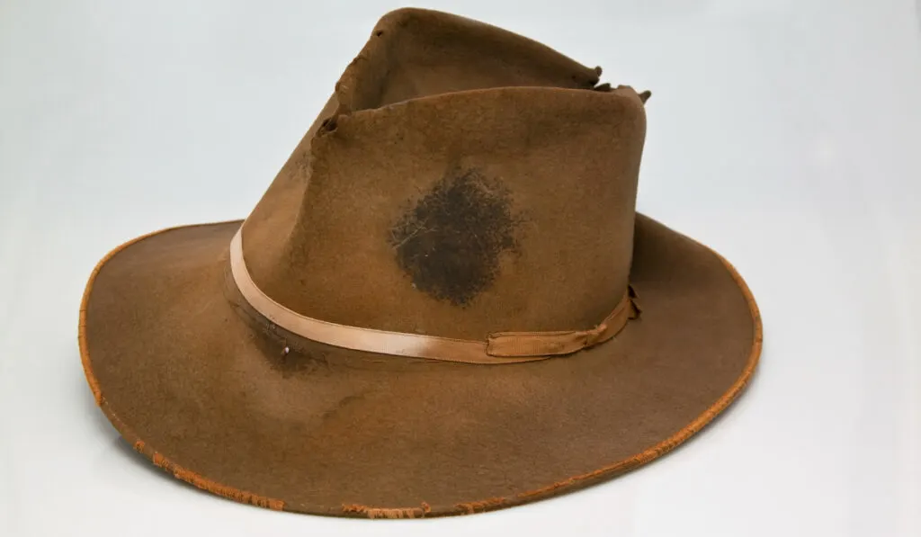 stained cowboy hat on white background