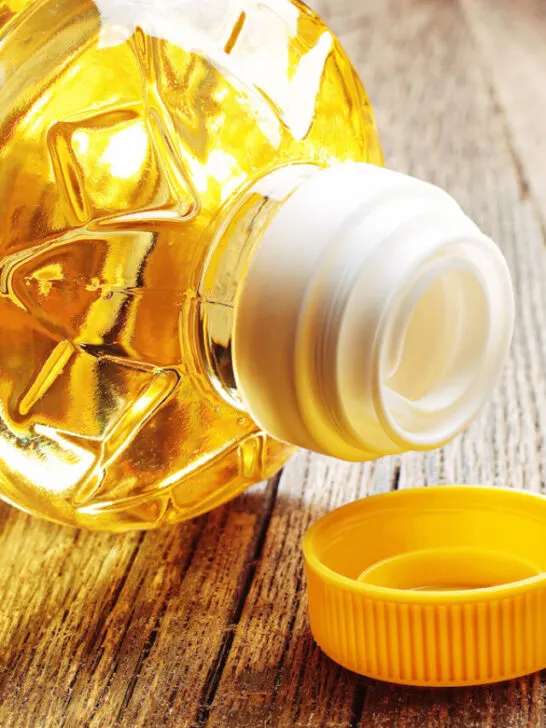 Vegetable oil in plastic bottle closeup on the old wooden table - ss240227