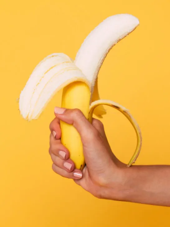 hand holding a banana