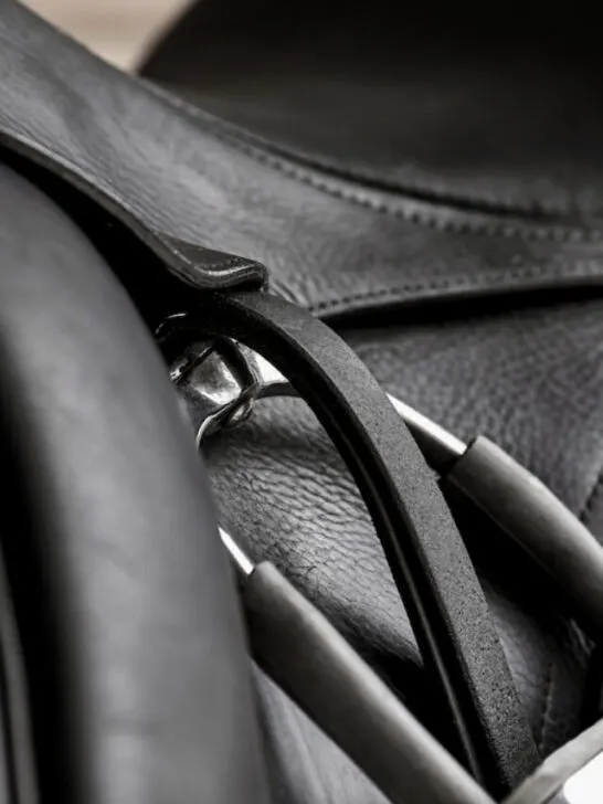 macro closeup of a black colored dressage saddle