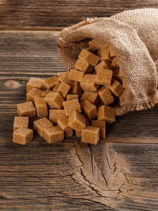 sugar cubes inside a burlap sack on top of the wooden table