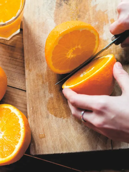 woman preparing an orange