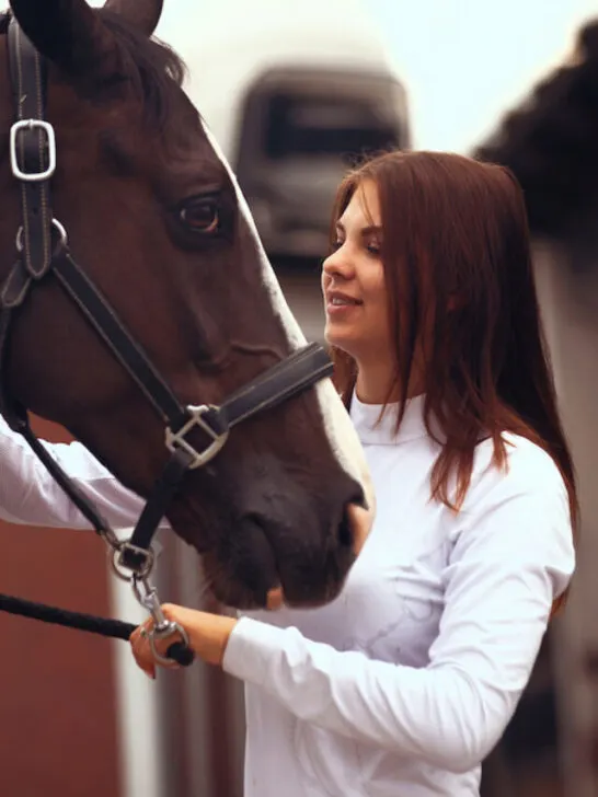 young equestrian rider with her horse