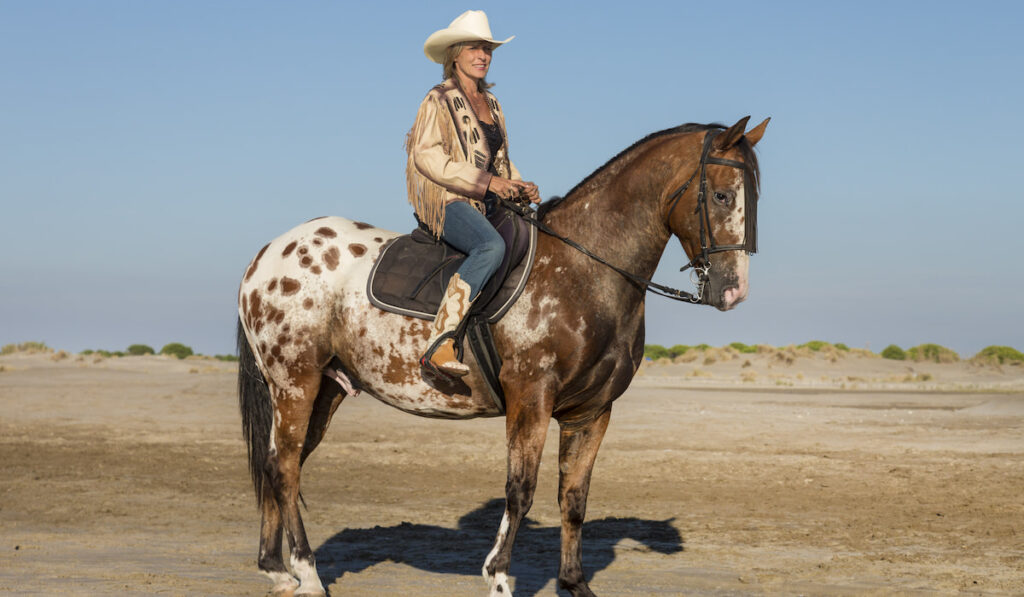 girl riding an Appaloosa horse 