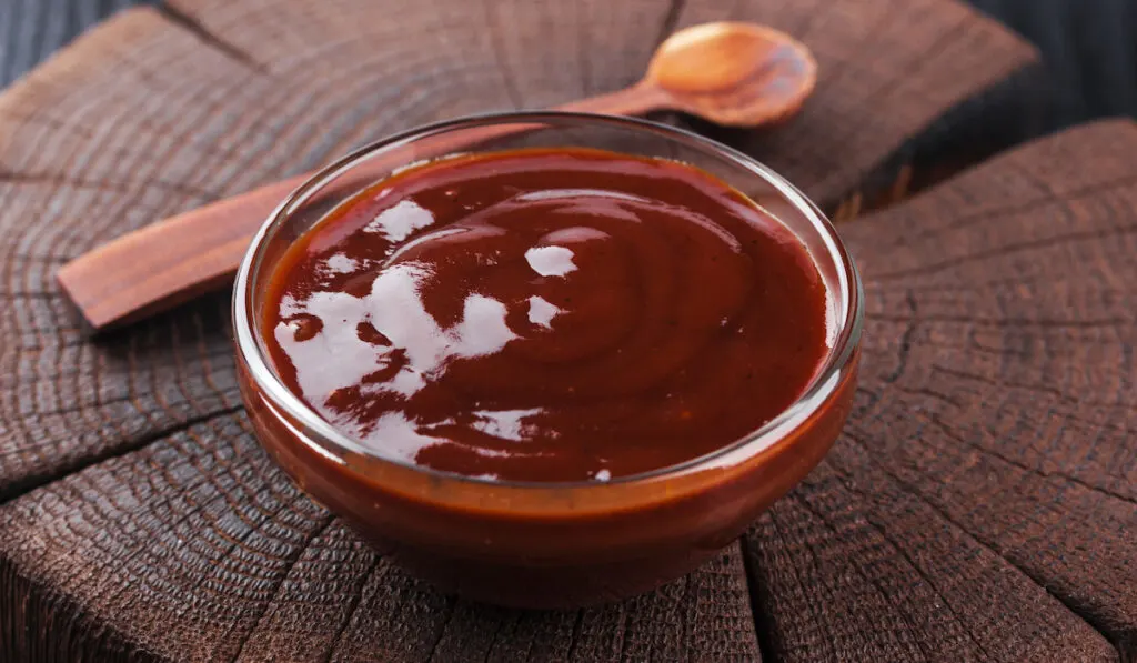 ketchup in a bowl and wooden spoon