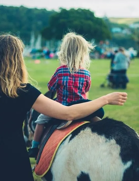 little girl riding a donkey