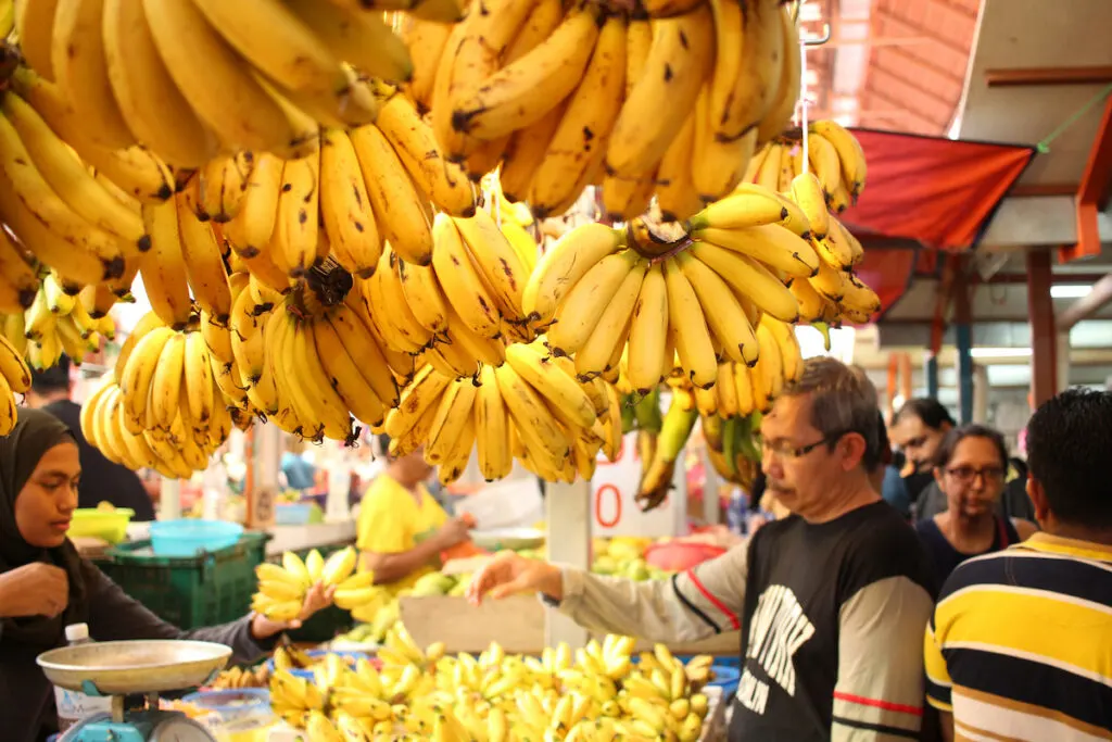 man buying bananas in the market