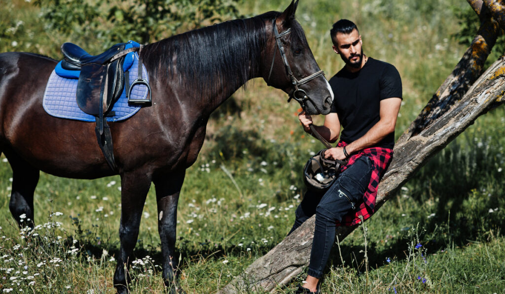 man sitting with the horse ee220326