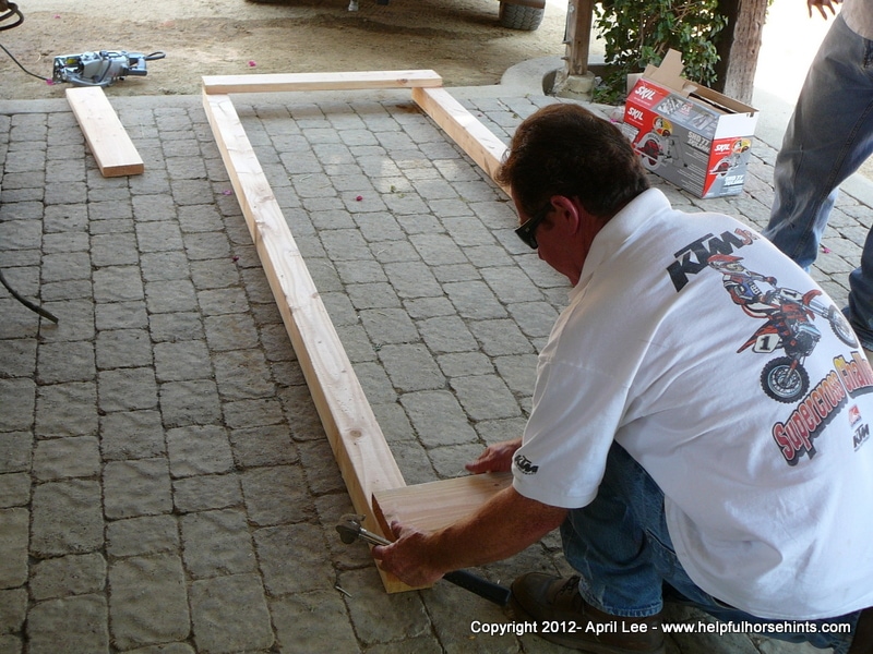 Man working on DIY horse bridge