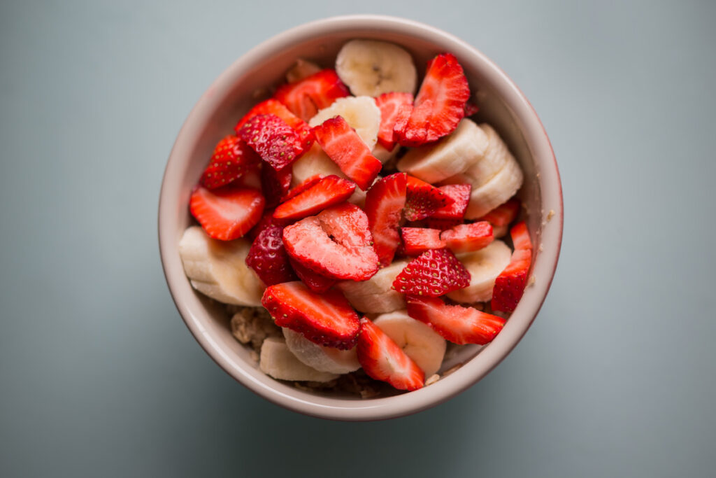 sliced bananas and strawberries in a bowl 