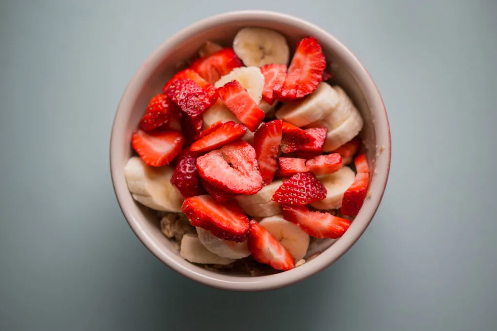 sliced bananas and strawberries in a bowl 