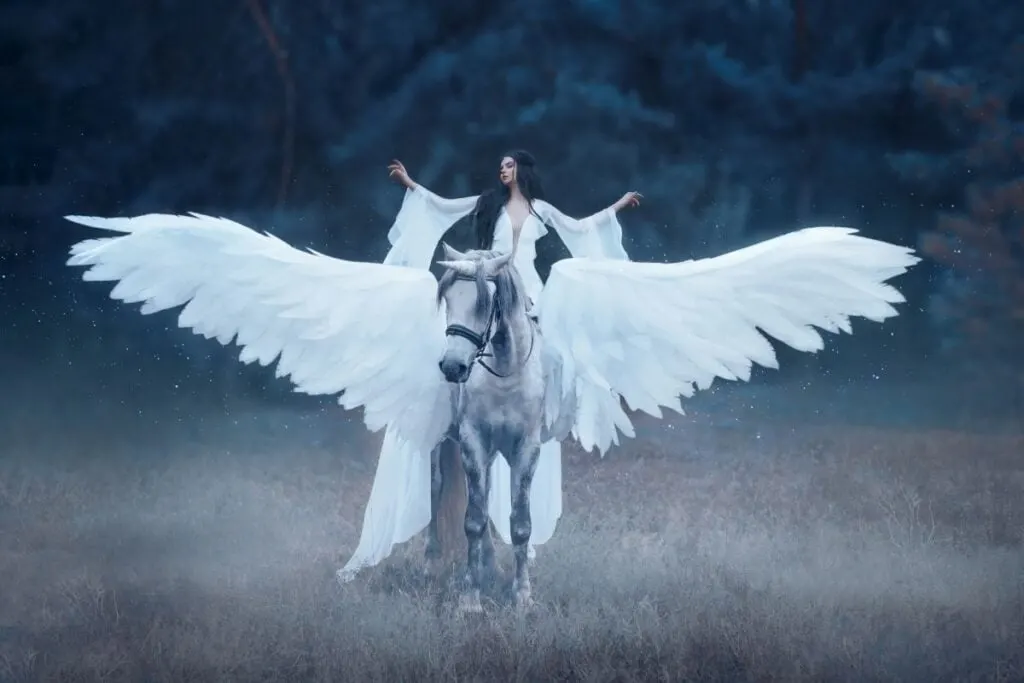 Beautiful woman riding white Pegasus