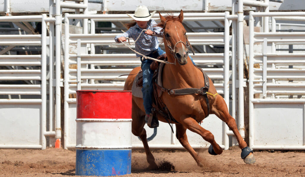 young woman practicing barrel racing