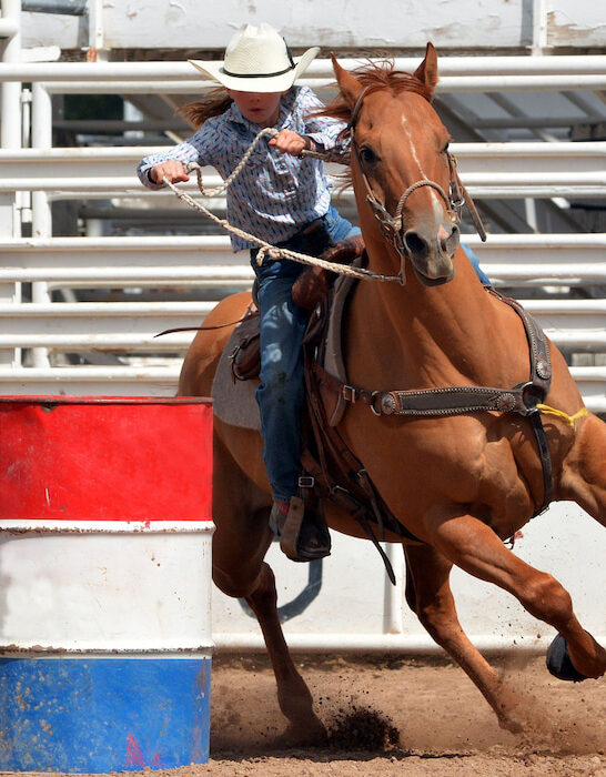 young woman practicing barrel racing